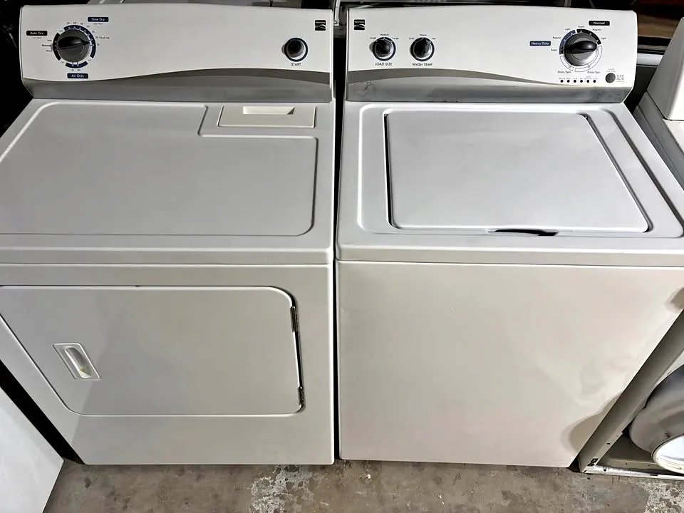 A washer and dryer set side by side
